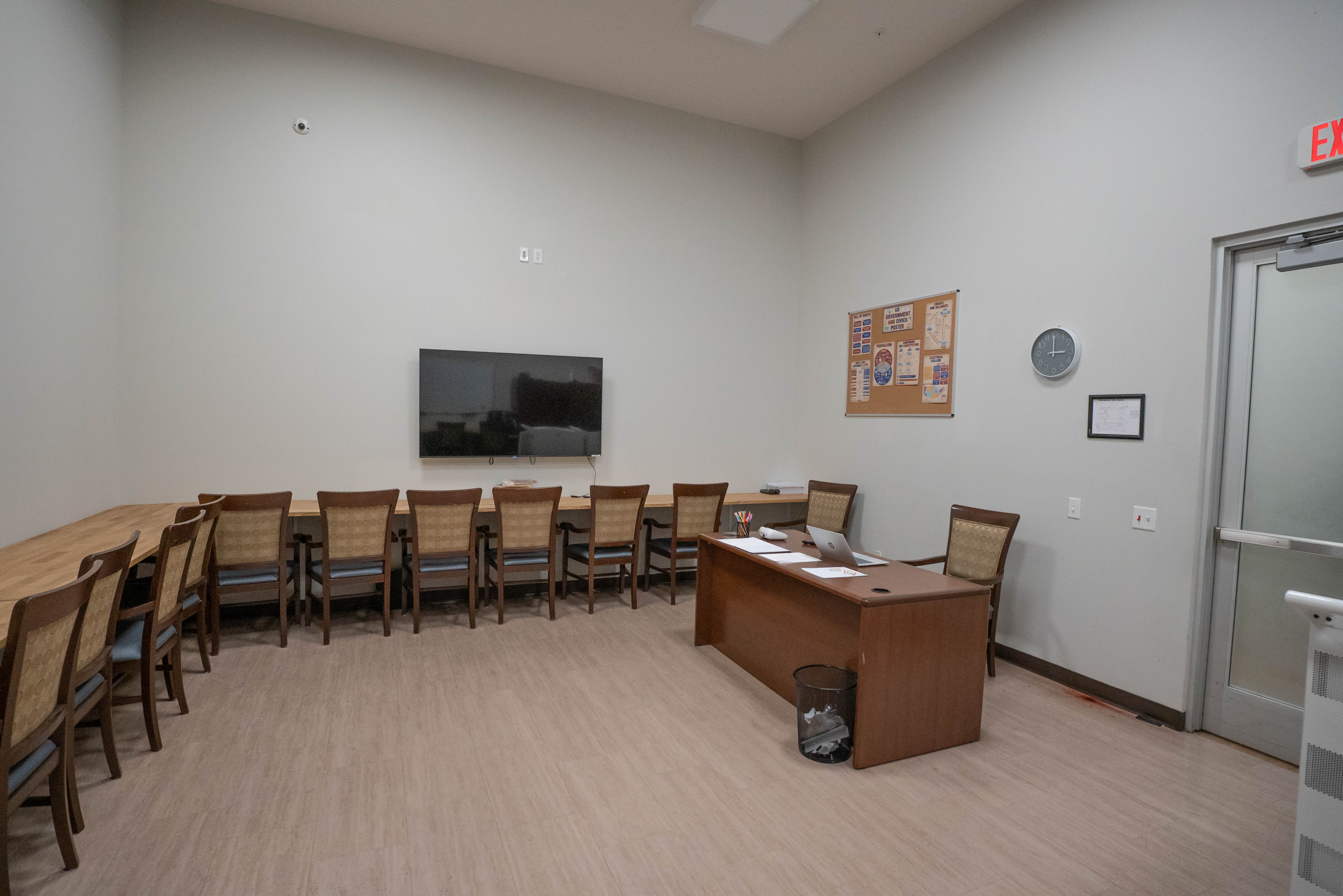 Certified teacher station with civics poster and laptop