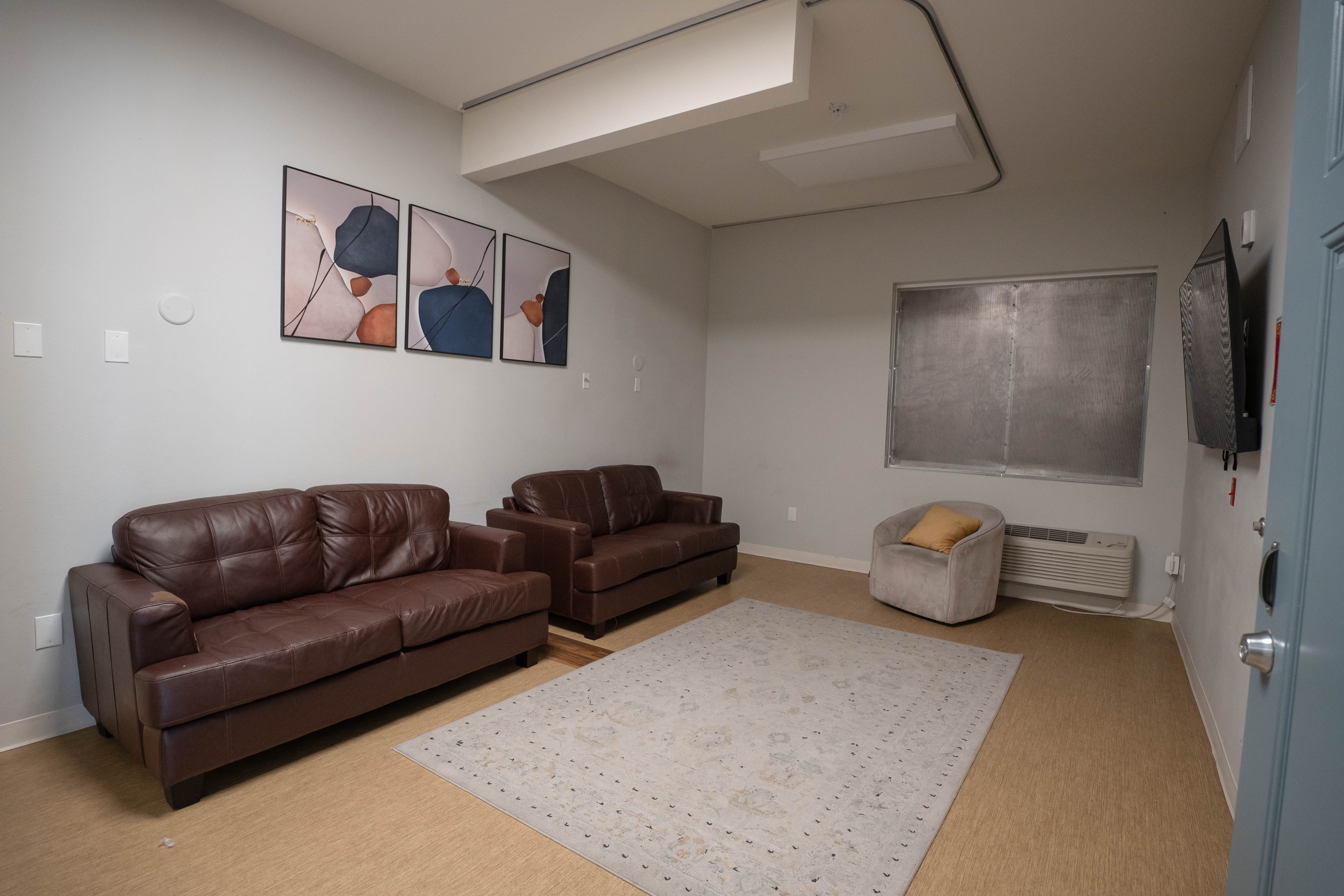 Silver State common area with leather sofas and wall art