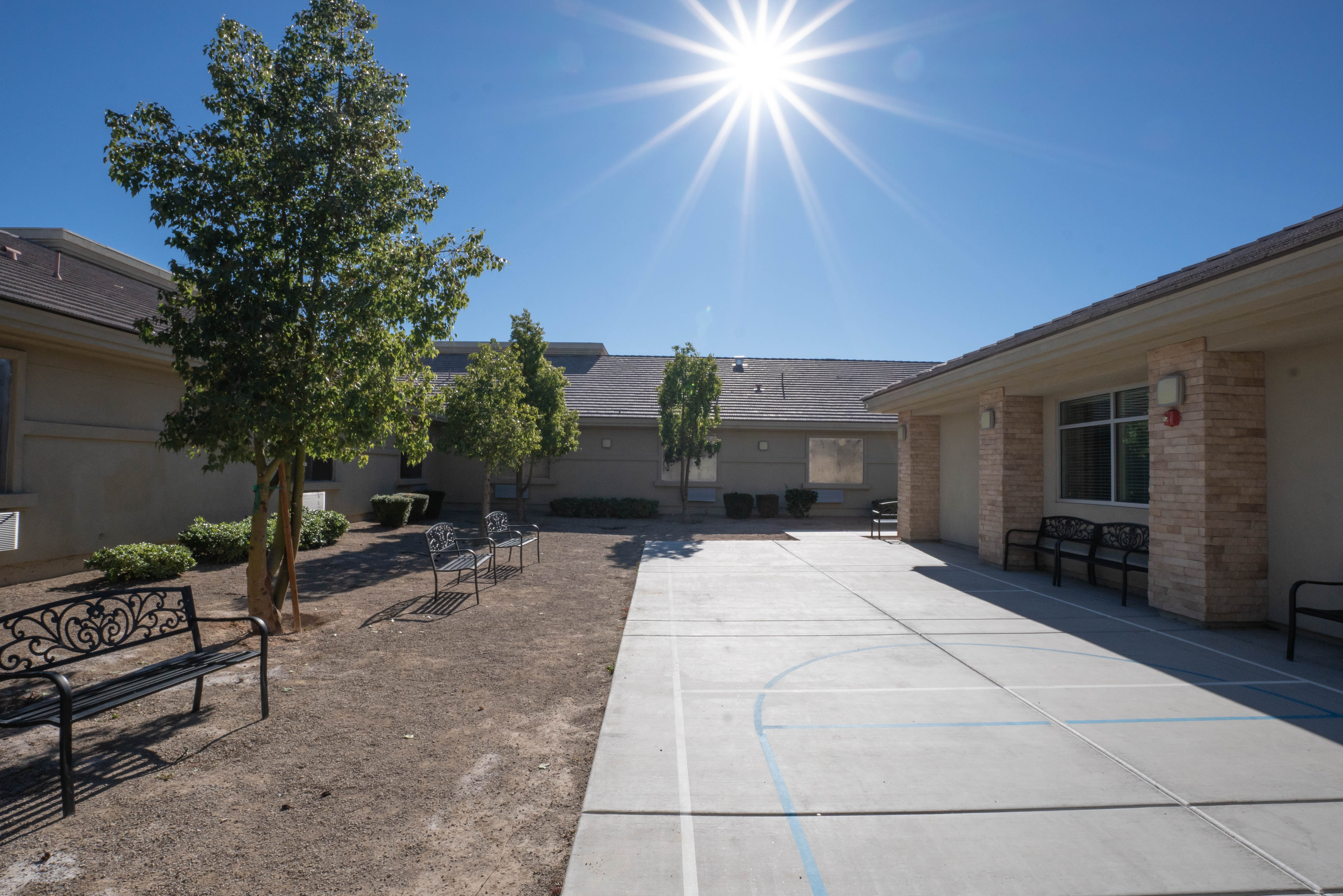 Outdoor courtyard with basketball court for physical activity