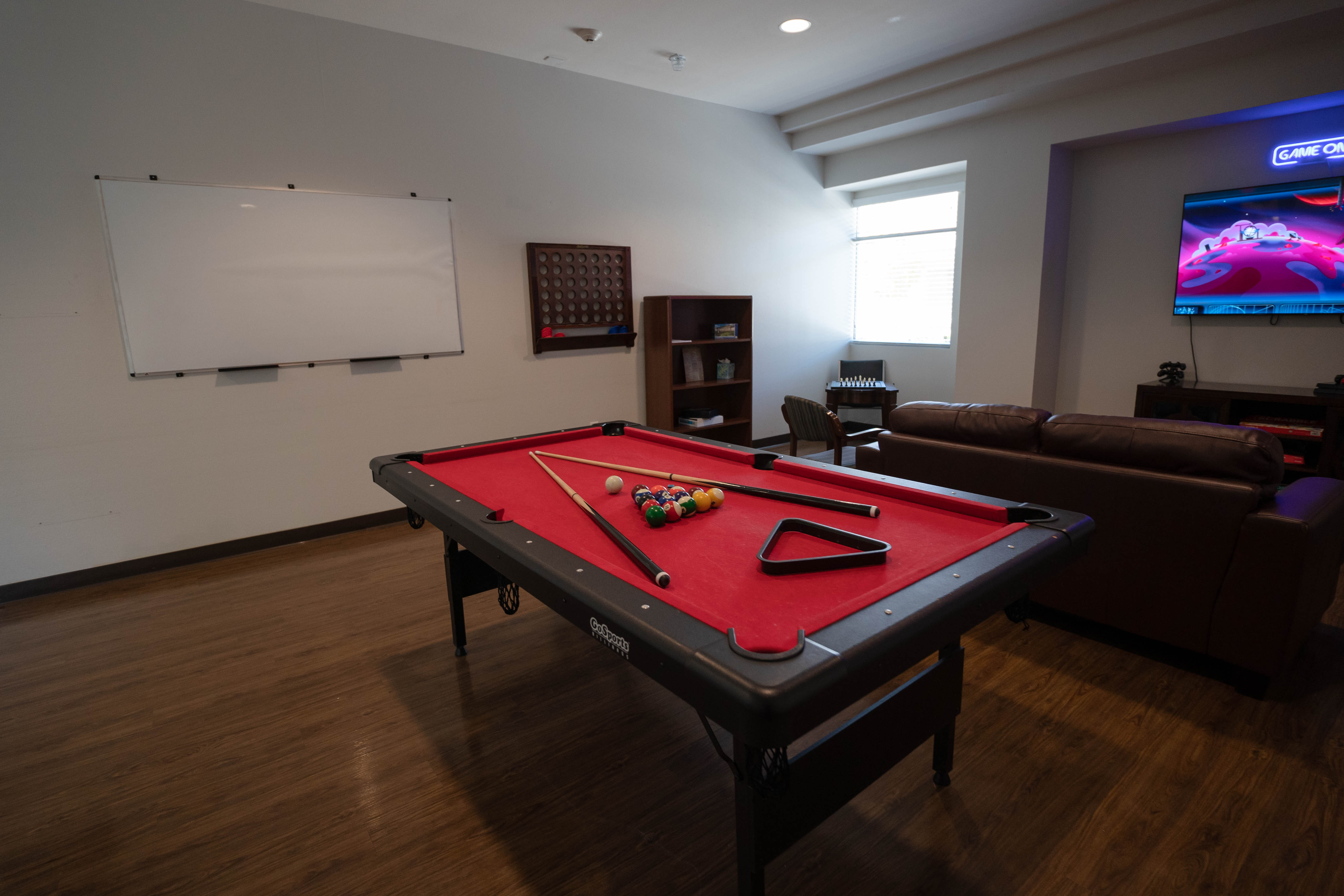 Silver State pool table with Game On neon sign