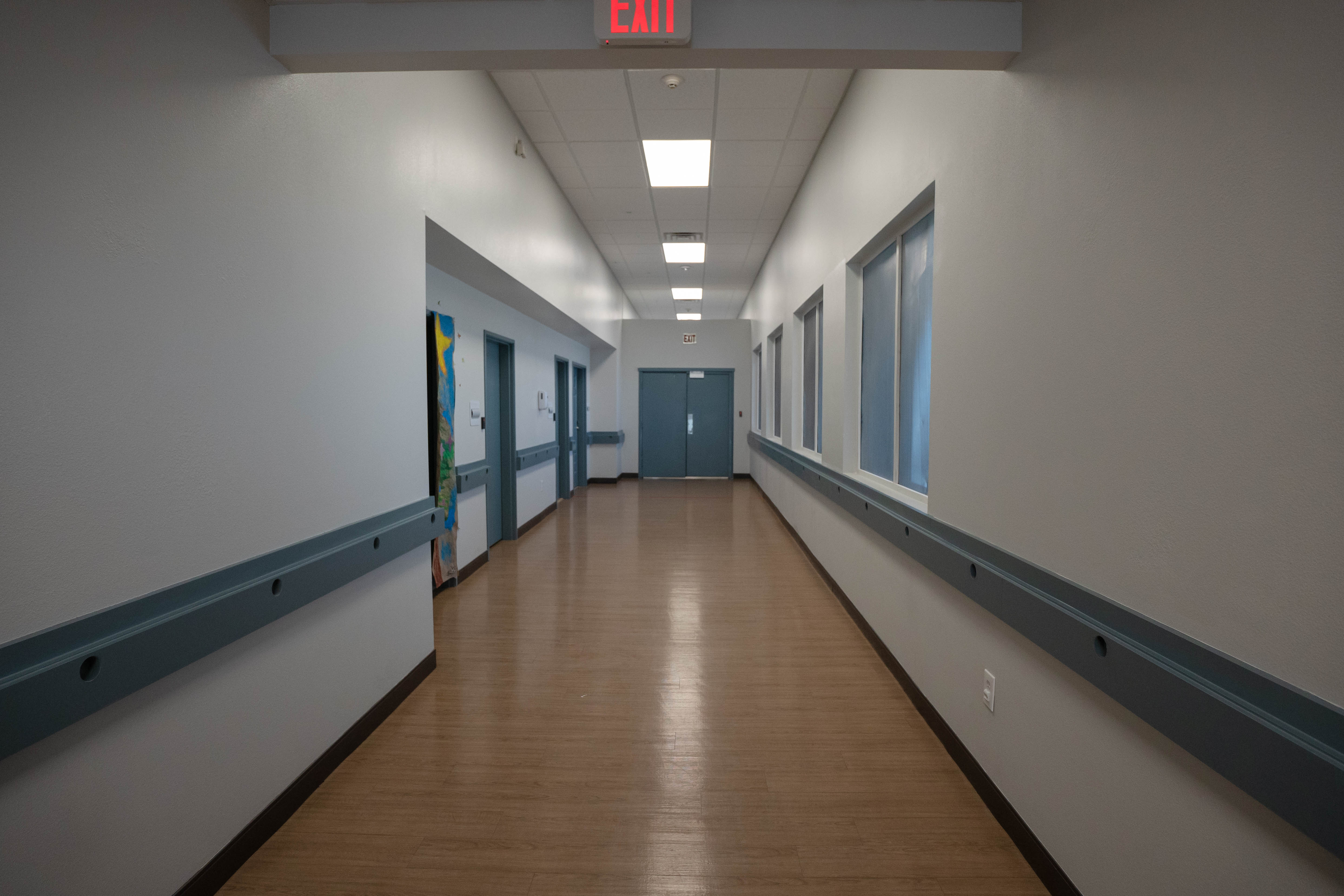 Silver State residential hallway with exit signs and art