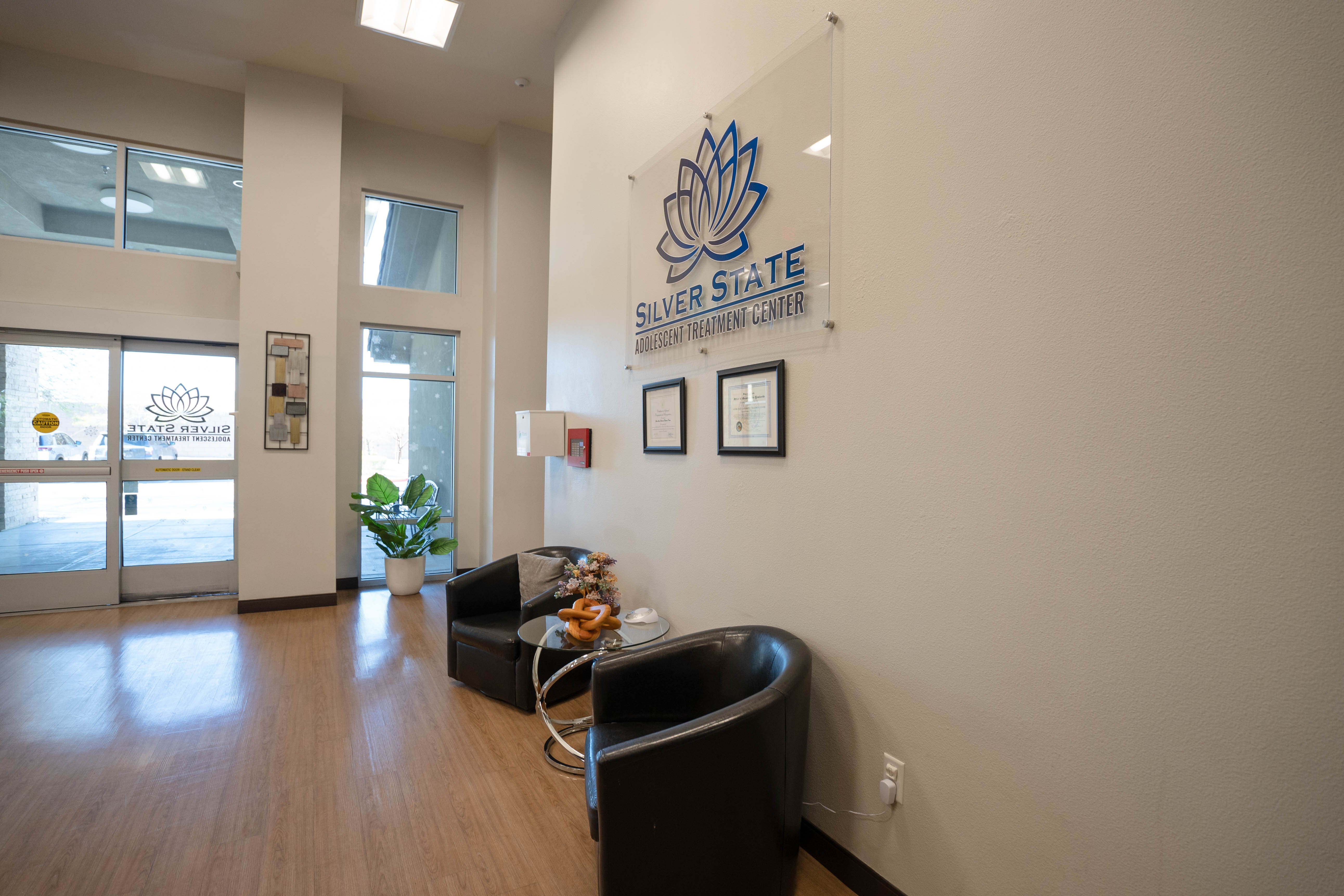 Silver State lobby entry with glass logo sign and seating