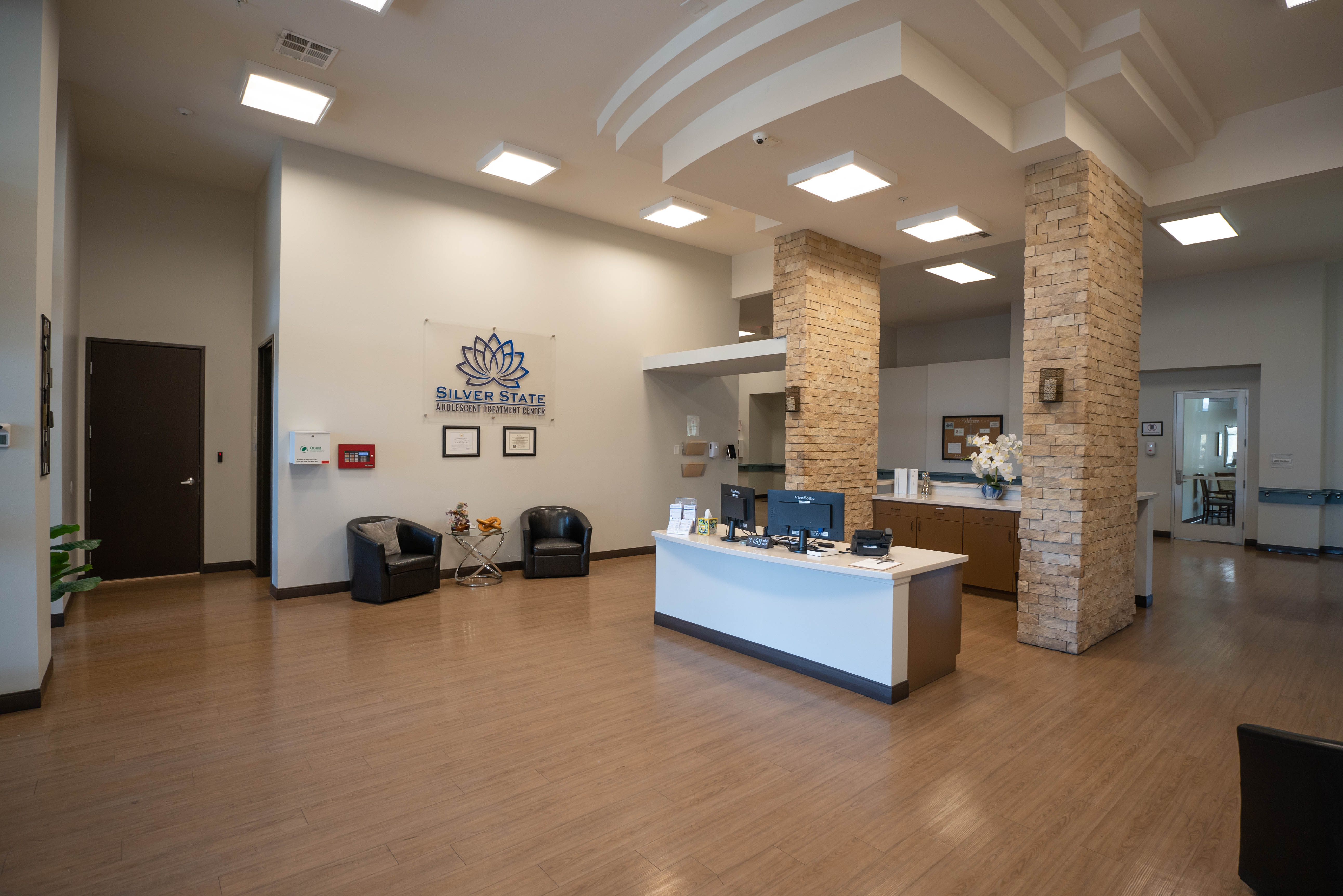 Silver State reception desk with logo sign and stone pillars